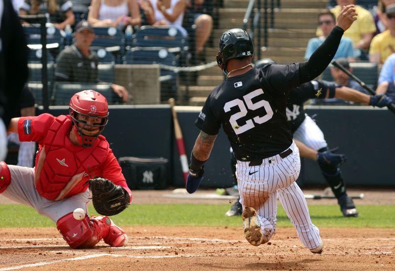 Mar 13, 2024; Tampa, Florida, USA; New York Yankees second baseman Gleyber Torres (25) slides safe into home plate as Boston Red Sox catcher Reese McGuire (3) attempts to tag him out during the first inning at George M. Steinbrenner Field. Mandatory Credit: Kim Klement Neitzel-USA TODAY Sports