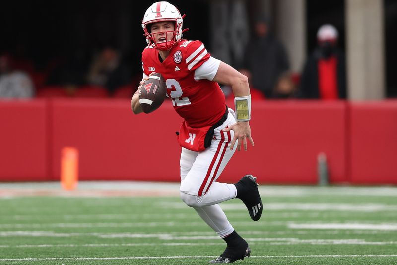 Nov 24, 2023; Lincoln, Nebraska, USA; Nebraska Cornhuskers quarterback Chubba Purdy (12) runs the football against the Iowa Hawkeyes at Memorial Stadium. Mandatory Credit: Reese Strickland-USA TODAY Sports