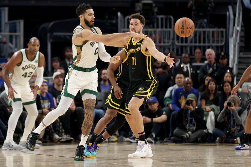 SAN FRANCISCO, CALIFORNIA - DECEMBER 19: Jayson Tatum #0 of the Boston Celtics passes around Klay Thompson #11 of the Golden State Warriors in the first half at Chase Center on December 19, 2023 in San Francisco, California. NOTE TO USER: User expressly acknowledges and agrees that, by downloading and or using this photograph, User is consenting to the terms and conditions of the Getty Images License Agreement.  (Photo by Ezra Shaw/Getty Images)