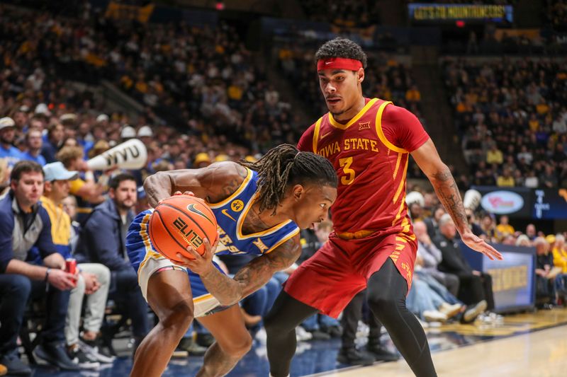 Jan 18, 2025; Morgantown, West Virginia, USA; West Virginia Mountaineers guard Javon Small (7) looks to dribble against Iowa State Cyclones guard Tamin Lipsey (3) during the first half at WVU Coliseum. Mandatory Credit: Ben Queen-Imagn Images