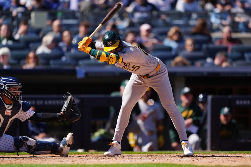 Apr 22, 2024; Bronx, New York, USA; Oakland Athletics designated hitter Brent Rooker (25) is hit by a pitch against the New York Yankees during the eighth inning at Yankee Stadium. Mandatory Credit: Gregory Fisher-USA TODAY Sports