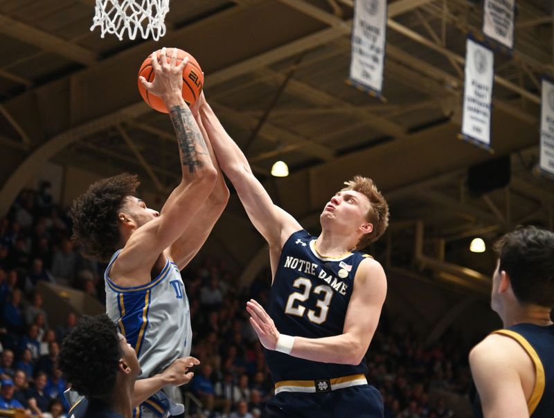 Feb 14, 2023; Durham, North Carolina, USA;  Notre Dame Fighting Irish guard Dane Goodwin (23) blocks a pass by Duke Blue Devils center Dereck Lively (1) during the second half at Cameron Indoor Stadium.  The Blue Devils won 68-64. Mandatory Credit: Rob Kinnan-USA TODAY Sports