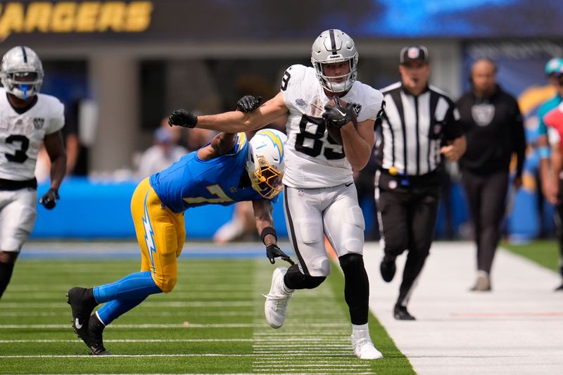 Las Vegas Raiders tight end Brock Bowers (89) runs against Los Angeles Chargers cornerback Kristian Fulton (7) during the first half of an NFL football game, Sunday, Sept. 8, 2024, in Inglewood, Calif. (AP Photo/Marcio Jose Sanchez)