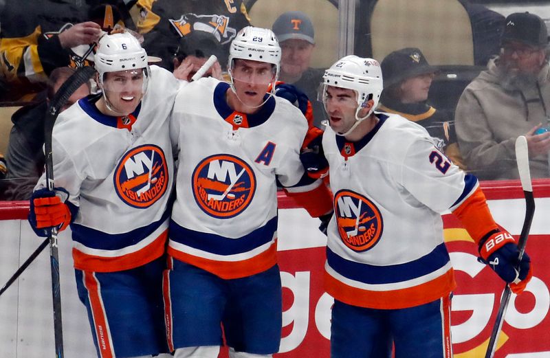 Feb 20, 2024; Pittsburgh, Pennsylvania, USA; New York Islanders center Brock Nelson (middle) celebrates with defensemen Ryan Pulock (6) and center Kyle Palmieri (21) after Nelson scored a goal against the Pittsburgh Penguins during the second period at PPG Paints Arena. Mandatory Credit: Charles LeClaire-USA TODAY Sports