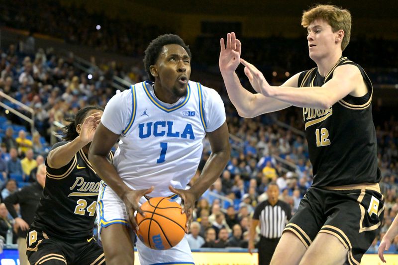 Jan 20, 2026; Los Angeles, California, USA;  UCLA Bruins forward Xavier Booker (1) is defended by Purdue Boilermakers guard Gicarri Harris (24) and center Daniel Jacobsen (12) as he drives to the basket in the first half at Pauley Pavilion presented by Wescom Financial. Mandatory Credit: Jayne Kamin-Oncea-Imagn Images