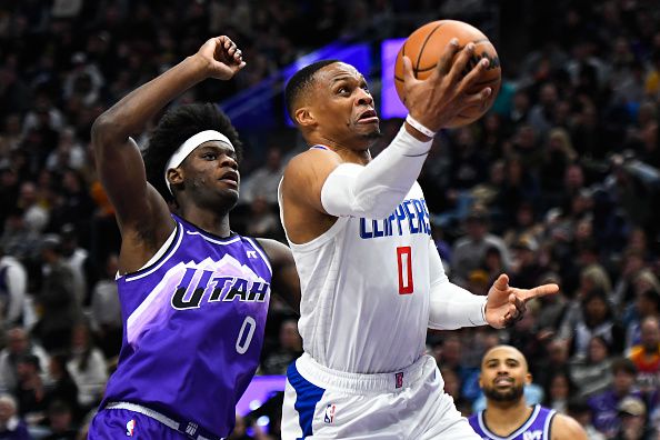 SALT LAKE CITY, UTAH - DECEMBER 08: Russell Westbrook #0 of the LA Clippers shoots over Taylor Hendricks #0 of the Utah Jazz during the second half of a game at Delta Center on December 08, 2023 in Salt Lake City, Utah. NOTE TO USER: User expressly acknowledges and agrees that, by downloading and or using this photograph, User is consenting to the terms and conditions of the Getty Images License Agreement. (Photo by Alex Goodlett/Getty Images)