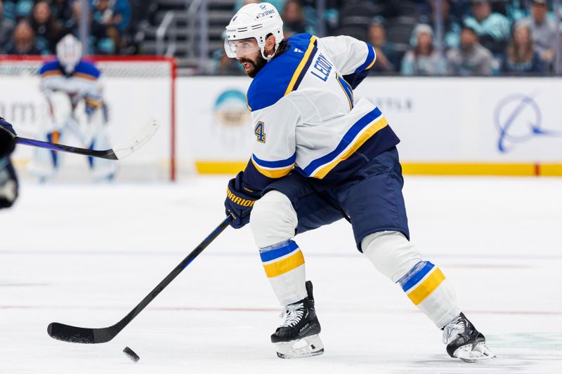 Oct 8, 2024; Seattle, Washington, USA; St. Louis Blues defenseman Nick Leddy (4) skates with the puck against the Seattle Kraken during the second period at Climate Pledge Arena. Mandatory Credit: Caean Couto-Imagn Images