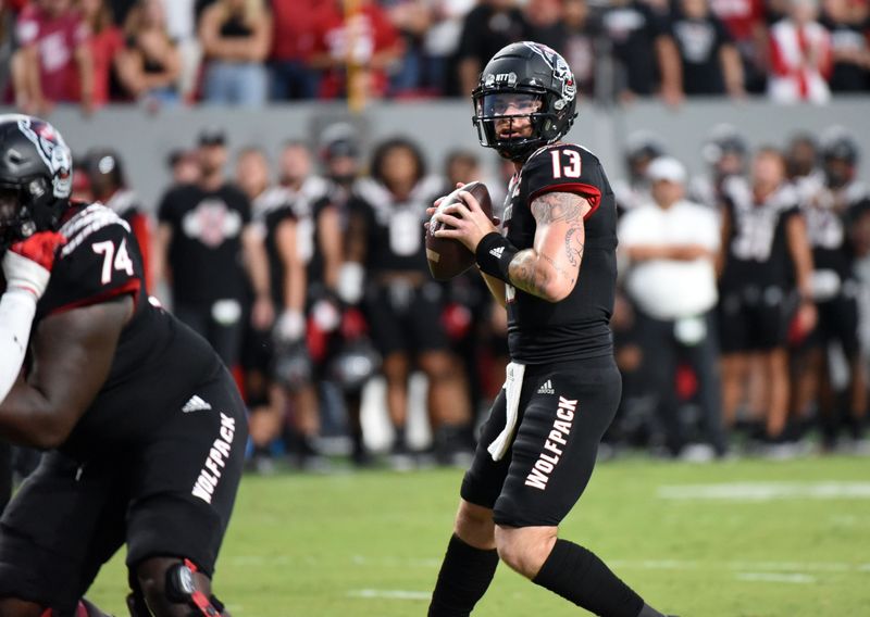 Sep 17, 2022; Raleigh, North Carolina, USA;  North Carolina State Wolfpack quarterback Devin Leary (13) looks to pass during the first half against  the Texas Tech Red Raiders at Carter-Finley Stadium. Mandatory Credit: Rob Kinnan-USA TODAY Sports