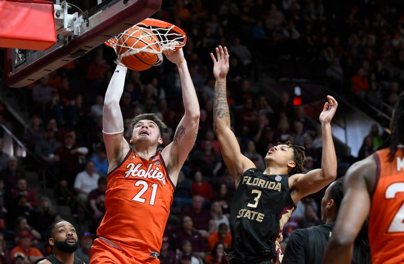 Mar 4, 2023; Blacksburg, Virginia, USA; Virginia Tech Hokies forward Grant Basile (21) dunks against Florida State Seminoles forward Cam Corhen (3) in the second half at Cassell Coliseum. Mandatory Credit: Lee Luther Jr.-USA TODAY Sports