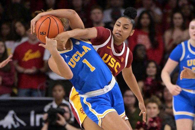 Jan 14, 2024; Los Angeles, California, USA; UCLA Bruins guard Kiki Rice (1) is fouled by USC Trojans guard JuJu Watkins (12) in the second half at Galen Center. Mandatory Credit: Jayne Kamin-Oncea-USA TODAY Sports