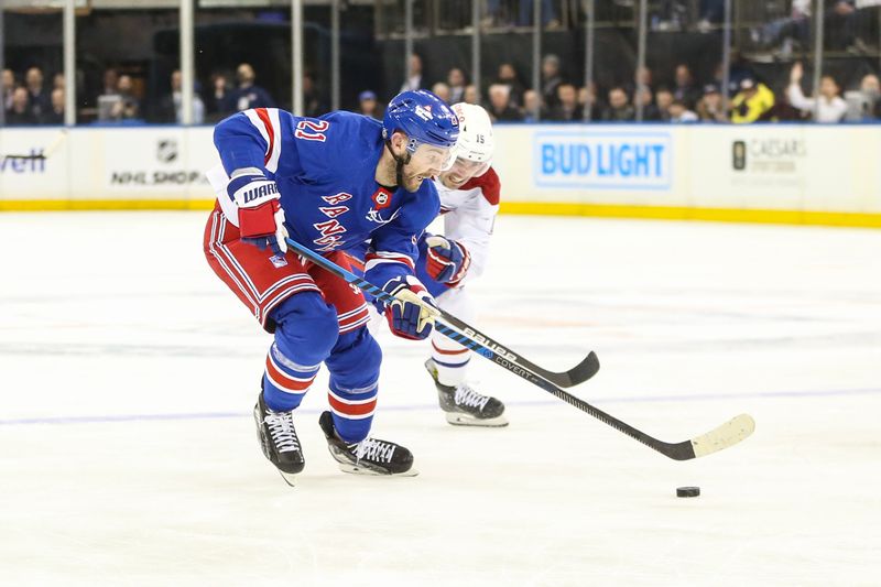 Feb 15, 2024; New York, New York, USA; New York Rangers center Barclay Goodrow (21) and Montreal Canadiens center Alex Newhook (15) battle for control of the puck in the second period at Madison Square Garden. Mandatory Credit: Wendell Cruz-USA TODAY Sports