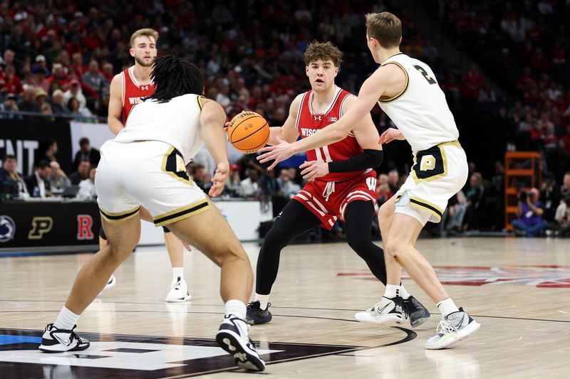 Mar 16, 2024; Minneapolis, MN, USA; Wisconsin Badgers guard Max Klesmit (11) passes as Purdue Boilermakers guard Fletcher Loyer (2) defends during the second half at Target Center. Mandatory Credit: Matt Krohn-USA TODAY Sports