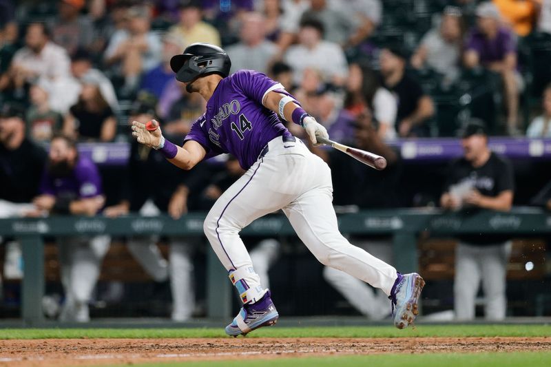 Jul 22, 2024; Denver, Colorado, USA; Colorado Rockies shortstop Ezequiel Tovar (14) hits a walk off RBI single in the twelfth inning against the Boston Red Sox at Coors Field. Mandatory Credit: Isaiah J. Downing-USA TODAY Sports