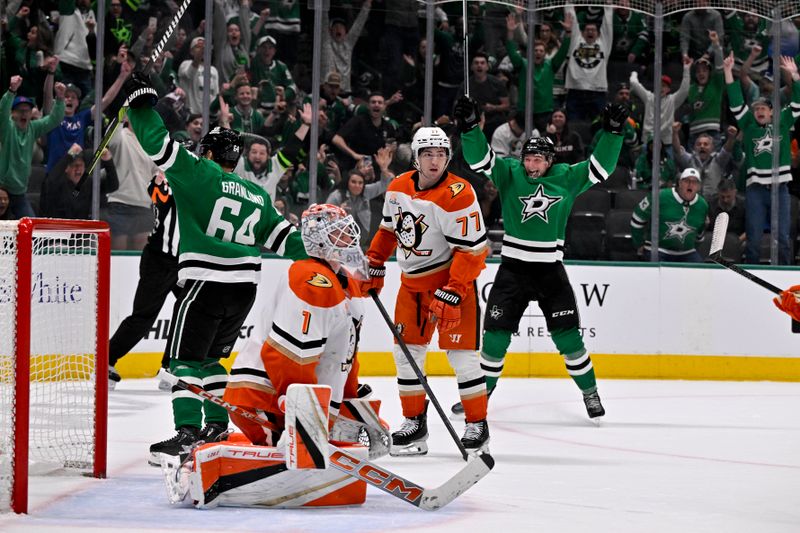 Mar 18, 2025; Dallas, Texas, USA; Dallas Stars center Mikael Granlund (64) and defenseman Thomas Harley (55) celebrate after Granlund scores the game winning goal over the Anaheim Ducks as goaltender Lukas Dostal (1) and right wing Frank Vatrano (77) look on during the overtime period at the American Airlines Center. Mandatory Credit: Jerome Miron-Imagn Images
