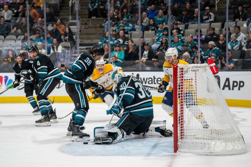 Jan 23, 2025; San Jose, California, USA;  San Jose Sharks goaltender Yaroslav Askarov (30) makes a save against the Nashville Predators during the third period at SAP Center at San Jose. Mandatory Credit: Neville E. Guard-Imagn Images