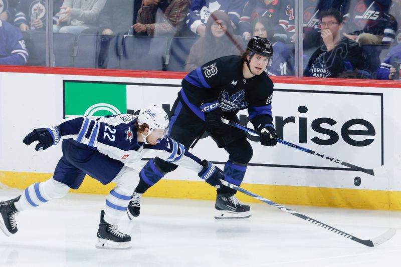 Oct 28, 2024; Winnipeg, Manitoba, CAN; Toronto Maple Leafs forward Matthew Knies (23) skates away from Winnipeg Jets forward Mason Appleton (22) during the third period at Canada Life Centre. Mandatory Credit: Terrence Lee-Imagn Images