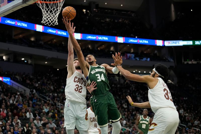 MILWAUKEE, WISCONSIN - NOVEMBER 02: Giannis Antetokounmpo #34 of the Milwaukee Bucks shoots the ball against Dean Wade #32 of the Cleveland Cavaliers during the third quarter of a game at Fiserv Forum on November 02, 2024 in Milwaukee, Wisconsin. NOTE TO USER: User expressly acknowledges and agrees that, by downloading and or using this photograph, User is consenting to the terms and conditions of the Getty Images License Agreement. (Photo by Patrick McDermott/Getty Images)