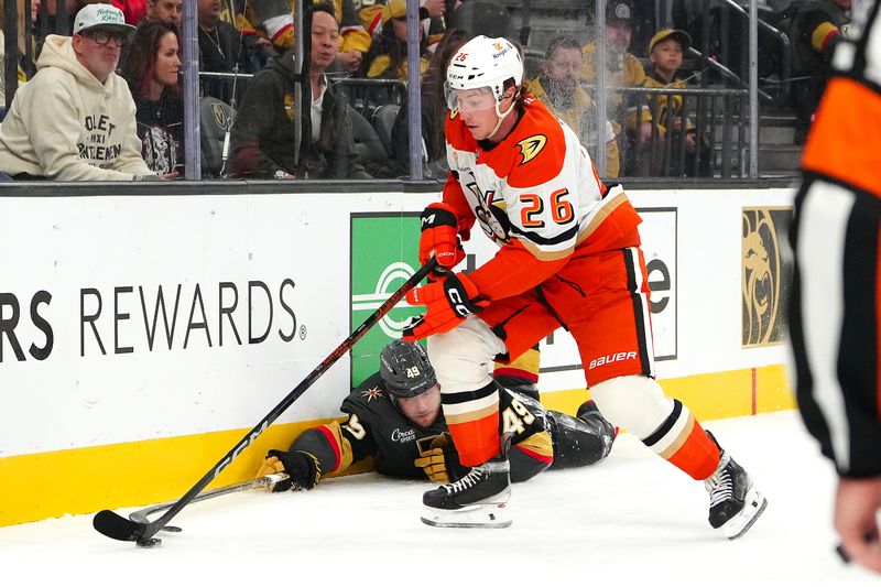 Oct 13, 2024; Las Vegas, Nevada, USA; Anaheim Ducks left wing Brock McGinn (26) steals the puck after Vegas Golden Knights center Ivan Barbashev (49) fell down during the second period at T-Mobile Arena. Mandatory Credit: Stephen R. Sylvanie-Imagn Images