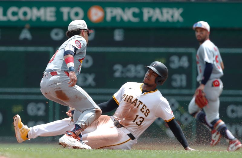 Jul 4, 2024; Pittsburgh, Pennsylvania, USA; St. Louis Cardinals shortstop Masyn Winn (0) tags Pittsburgh Pirates third baseman Ke'Bryan Hayes (13) out at second base on a steal attempt during the fifth inning at PNC Park. Mandatory Credit: Charles LeClaire-USA TODAY Sports