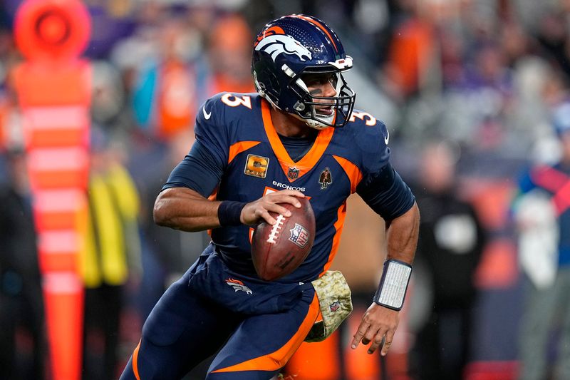 Denver Broncos quarterback Russell Wilson (3) scrambles against the Minnesota Vikings during the first half on an NFL football game, Sunday, Nov. 19, 2023, in Denver. (AP Photo/Jack Dempsey)