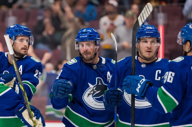 Oct 7, 2022; Vancouver, British Columbia, CAN; Vancouver Canucks forward Bo Horvat (53) celebrates after scoring a goal against the Arizona Coyotes with defenseman Oliver Ekman-Larsson (23) and forward J.T. Miller (9) and forward Andrei Kuzmenko (96) in the first period at Rogers Arena. Mandatory Credit: Bob Frid-USA TODAY Sports