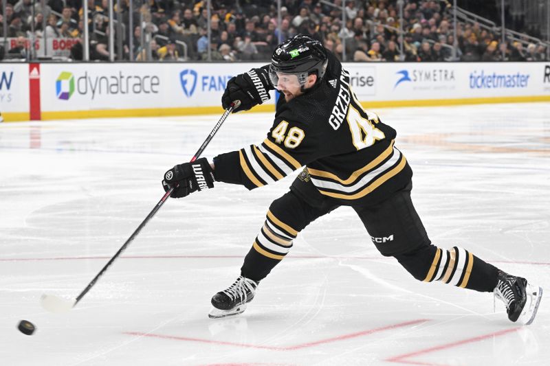 Feb 15, 2024; Boston, Massachusetts, USA; Boston Bruins defenseman Matt Grzelcyk (48) shoots the puck against the Seattle Kraken during the third period at the TD Garden. Mandatory Credit: Brian Fluharty-USA TODAY Sports