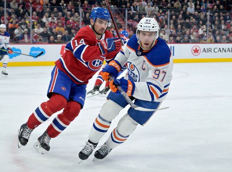 Nov 18, 2024; Montreal, Quebec, CAN; Montreal Canadiens forward Nick Suzuki (14) and Edmonton Oilers forward Connor McDavid (97) track the puck during the first period at the Bell Centre. Mandatory Credit: Eric Bolte-Imagn Images