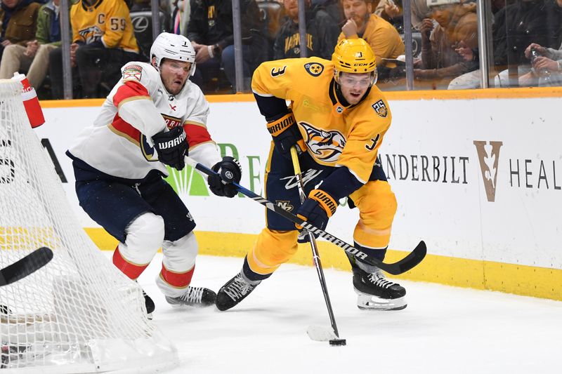 Jan 22, 2024; Nashville, Tennessee, USA; Nashville Predators defenseman Jeremy Lauzon (3) handles the puck behind the net against Florida Panthers defenseman Dmitry Kulikov (7) during the third period at Bridgestone Arena. Mandatory Credit: Christopher Hanewinckel-USA TODAY Sports