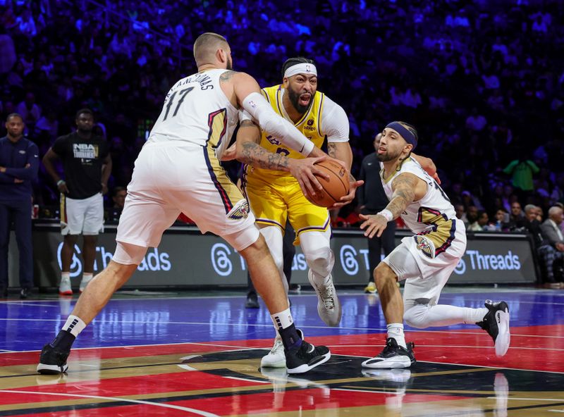 LAS VEGAS, NEVADA - DECEMBER 07: Anthony Davis #3 of the Los Angeles Lakers is fouled by Jonas Valanciunas #17 of the New Orleans Pelicans in the first half of the West semifinal game of the inaugural NBA In-Season Tournament at T-Mobile Arena on December 07, 2023 in Las Vegas, Nevada. NOTE TO USER: User expressly acknowledges and agrees that, by downloading and or using this photograph, User is consenting to the terms and conditions of the Getty Images License Agreement.  (Photo by Ethan Miller/Getty Images)