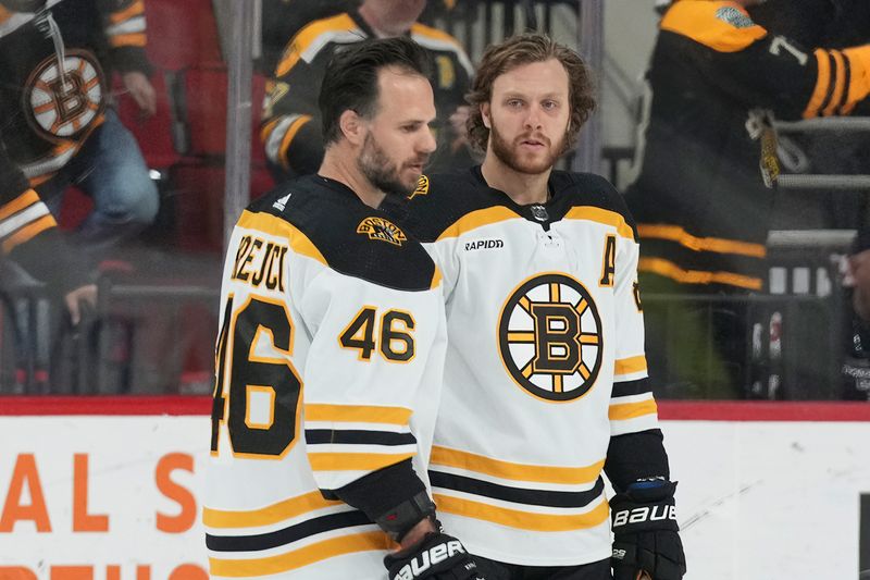 Mar 26, 2023; Raleigh, North Carolina, USA;  Boston Bruins center David Krejci (46) and right wing David Pastrnak (88) look on during the warmups before the game against the Carolina Hurricanes at PNC Arena. Mandatory Credit: James Guillory-USA TODAY Sports