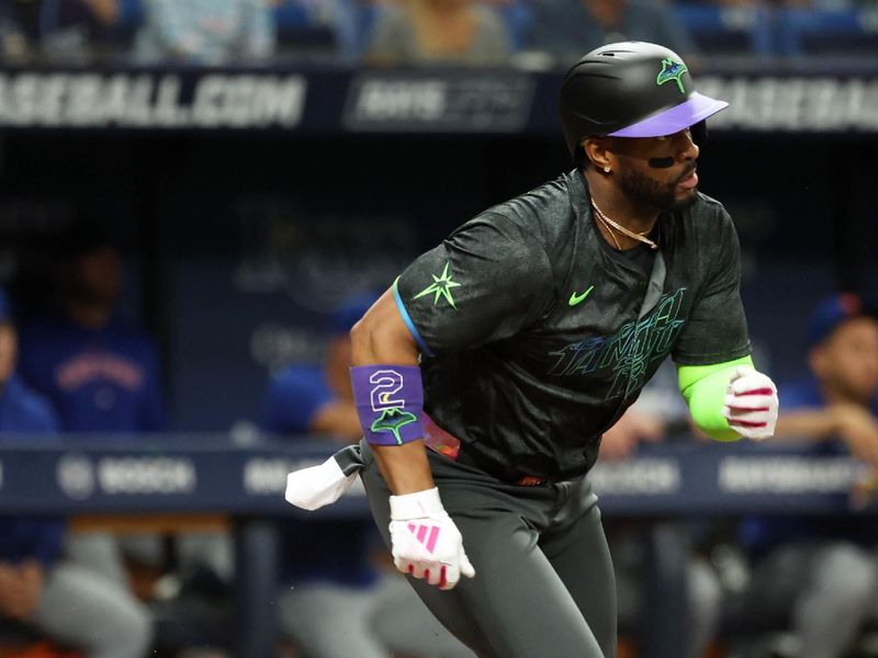 May 3, 2024; St. Petersburg, Florida, USA;  Tampa Bay Rays first base Yandy Díaz (2) hits a RBI single against the New York Mets during the third inning at Tropicana Field. Mandatory Credit: Kim Klement Neitzel-USA TODAY Sports