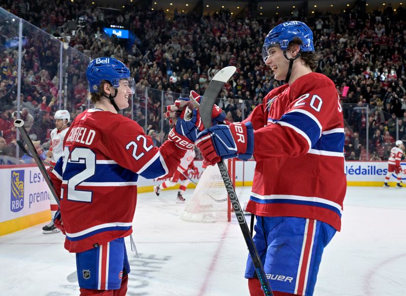 Apr 16, 2024; Montreal, Quebec, CAN; Montreal Canadiens forward Cole Caufield (22) celebrates with forward Juraj Slafkovsky (20) after scoring a goal against the Detroit Red Wings during the second period at the Bell Centre. Mandatory Credit: Eric Bolte-USA TODAY Sports