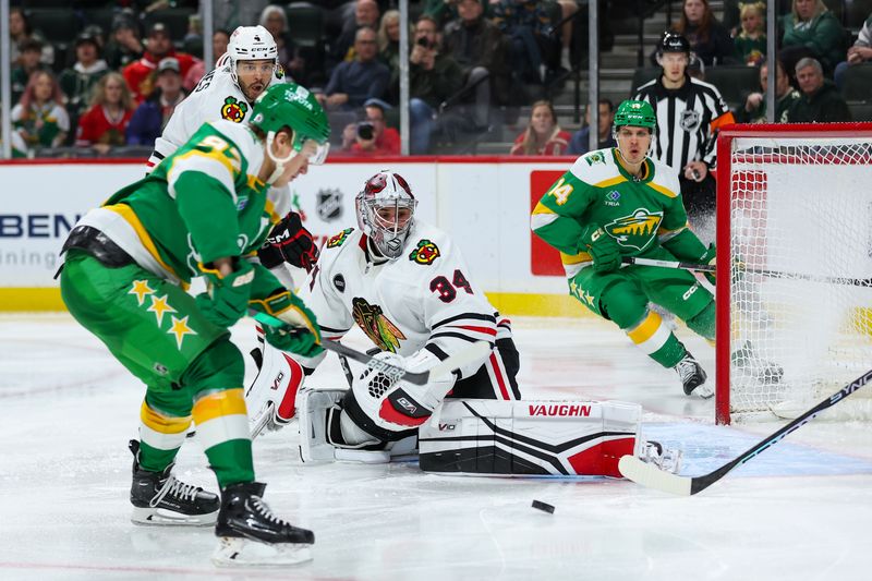 Dec 3, 2023; Saint Paul, Minnesota, USA; Chicago Blackhawks goaltender Petr Mrazek (34) makes a save on a shot from Minnesota Wild left wing Kirill Kaprizov (97) during the second period at Xcel Energy Center. Mandatory Credit: Matt Krohn-USA TODAY Sports