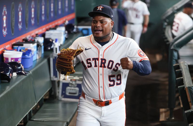 May 24, 2025; Houston, Texas, USA; Houston Astros starting pitcher Framber Valdez (59) walks in the dugout before the game against the Seattle Mariners at Daikin Park. Mandatory Credit: Troy Taormina-Imagn Images