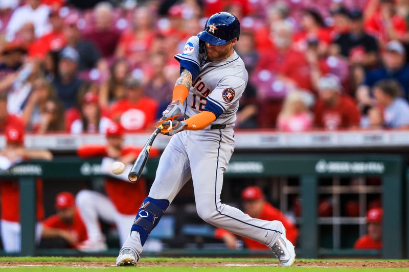 Sep 4, 2024; Cincinnati, Ohio, USA; Houston Astros outfielder Ben Gamel (12) hits a RBI single in the second inning against the Cincinnati Reds at Great American Ball Park. Mandatory Credit: Katie Stratman-Imagn Images