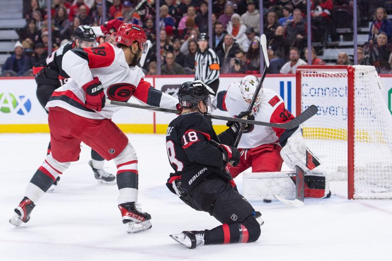 Jan 24, 2026; Ottawa, Ontario, CAN; Carolina Hurricanes goalie Brandon Bussi (32) makes a save on a shot from Ottawa Senators center Tim Stutzle (18) in the first period at the Canadian Tire Centre. Mandatory Credit: Marc DesRosiers-IMAGN Images