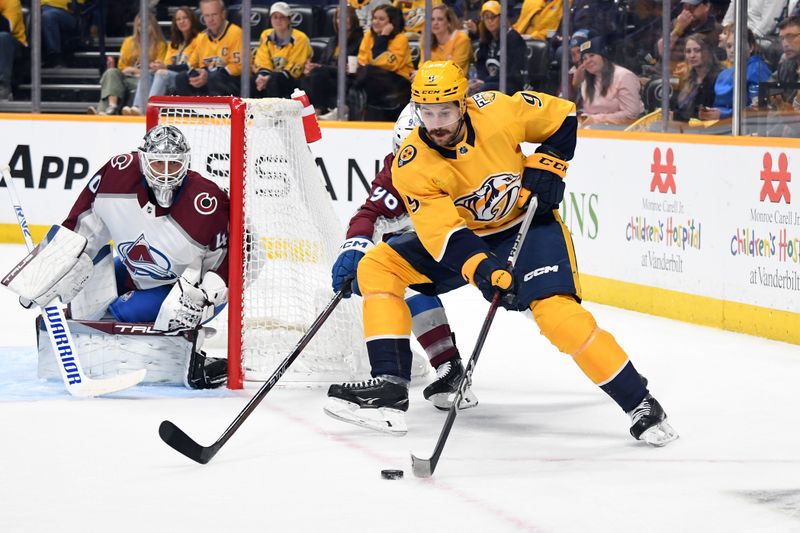 Mar 2, 2024; Nashville, Tennessee, USA; Nashville Predators left wing Filip Forsberg (9) handles the puck against Colorado Avalanche right wing Mikko Rantanen (96) during the first period at Bridgestone Arena. Mandatory Credit: Christopher Hanewinckel-USA TODAY Sports