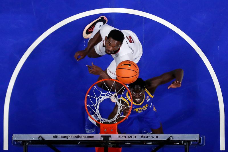 Feb 17, 2024; Pittsburgh, Pennsylvania, USA;  Louisville Cardinals forward Brandon Huntley-Hatfield (5) and Pittsburgh Panthers center Federiko Federiko (33) look for a rebound during the second half at the Petersen Events Center. Pittsburgh won 86-59. Mandatory Credit: Charles LeClaire-USA TODAY Sports