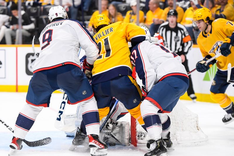 Apr 13, 2024; Nashville, Tennessee, USA; Columbus Blue Jackets goaltender Jet Greaves (73) blocks the shot of Nashville Predators left wing Anthony Beauvillier (21) during the third period at Bridgestone Arena. Mandatory Credit: Steve Roberts-USA TODAY Sports