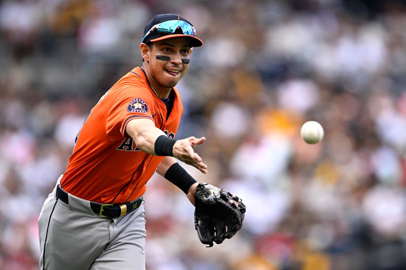 Sep 18, 2024; San Diego, California, USA; Houston Astros second baseman Mauricio Dubon (14) tosses the ball to first base on a bunt by San Diego Padres left fielder Jurickson Profar (not pictured) during the third inning at Petco Park. Mandatory Credit: Orlando Ramirez-Imagn Images