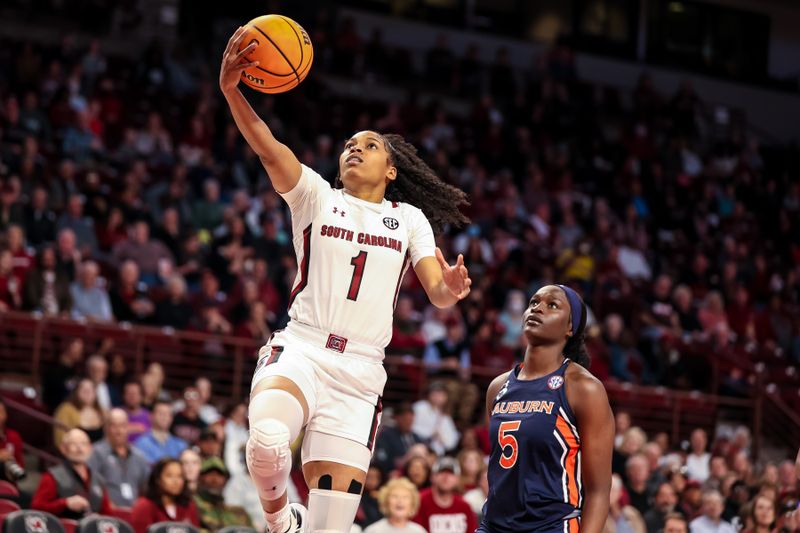 Jan 5, 2023; Columbia, South Carolina, USA; South Carolina Gamecocks guard Zia Cooke (1) drives past Auburn Tigers guard Aicha Coulibaly (5) in the first half at Colonial Life Arena. Mandatory Credit: Jeff Blake-USA TODAY Sports