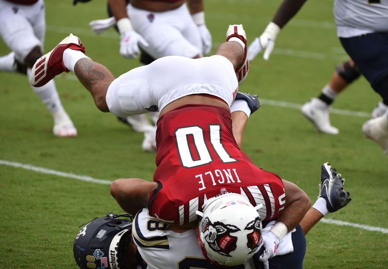 Sep 10, 2022; Raleigh, North Carolina, USA;Charleston Southern Buccaneers receiver Kale Anderson (88) is hit by North Carolina State Wolfpack defensive back Tanner Ingle (10) during the first half at Carter-Finley Stadium. Mandatory Credit: Rob Kinnan-USA TODAY Sports