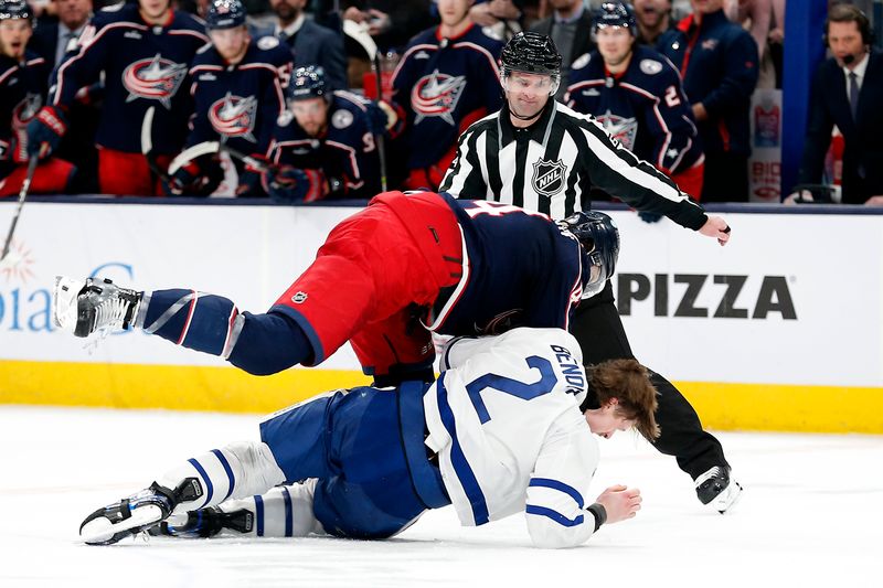 Dec 29, 2023; Columbus, Ohio, USA; Columbus Blue Jackets defenseman Erik Gudbranson (44) and Toronto Maple Leafs defenseman Simon Benoit (2) fight during the second period at Nationwide Arena. Mandatory Credit: Russell LaBounty-USA TODAY Sports