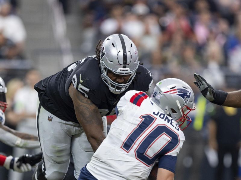 Las Vegas Raiders defensive tackle John Jenkins (95) sacks New England Patriots quarterback Mac Jones (10) in an NFL football game, Sunday, Oct. 15, 2023, in Las Vegas, NV. Raiders won 21-17. (AP Photo/Jeff Lewis)