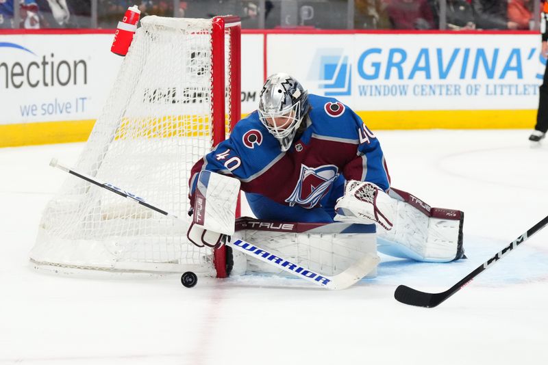 Jan 24, 2023; Denver, Colorado, USA; Colorado Avalanche goaltender Alexandar Georgiev (40) reaches for the puck in the first period against the Washington Capitals at Ball Arena. Mandatory Credit: Ron Chenoy-USA TODAY Sports