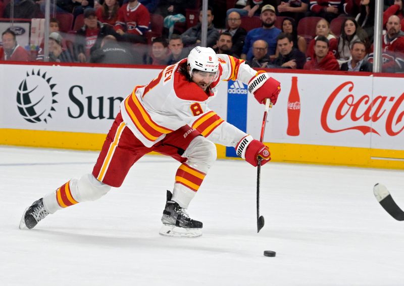 Nov 14, 2023; Montreal, Quebec, CAN; Calgary Flames defenseman Chris Tanev (8) shoots the puck during the second period of the game against the Montreal Canadiens at the Bell Centre. Mandatory Credit: Eric Bolte-USA TODAY Sports