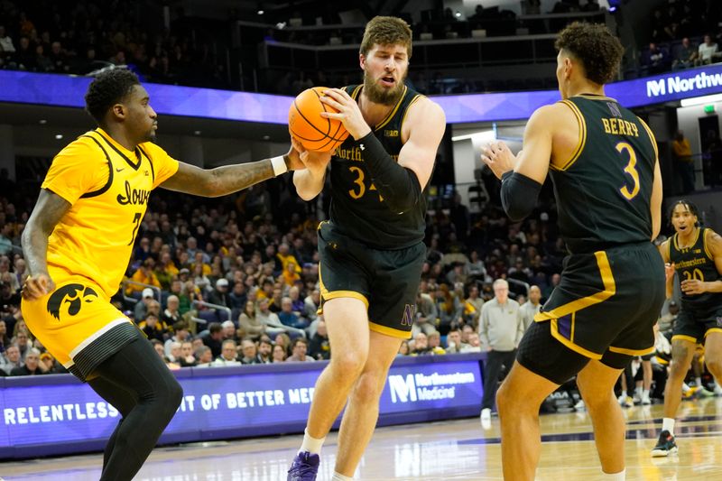 Feb 28, 2025; Evanston, Illinois, USA; Iowa Hawkeyes forward Seydou Traore (7) defends Northwestern Wildcats center Matthew Nicholson (34) during the second half at Welsh-Ryan Arena. Mandatory Credit: David Banks-Imagn Images