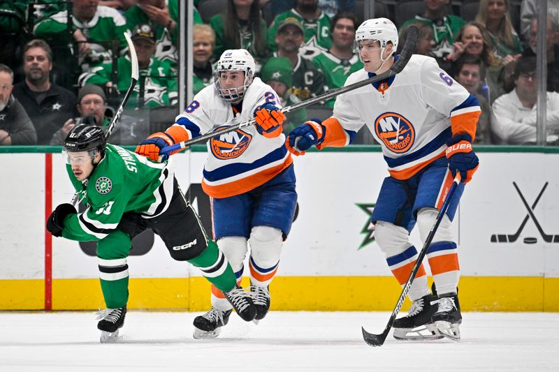 Feb 26, 2024; Dallas, Texas, USA; New York Islanders defenseman Alexander Romanov (28) checks Dallas Stars center Logan Stankoven (11) as Islanders defenseman Ryan Pulock (6) looks on during the first period at the American Airlines Center. Mandatory Credit: Jerome Miron-USA TODAY Sports