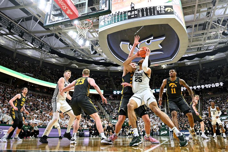 Feb 20, 2024; East Lansing, Michigan, USA;  Michigan State Spartans forward Malik Hall (25) works down the baseline against an Iowa Hawkeyes defender during the second half at Jack Breslin Student Events Center. Mandatory Credit: Dale Young-USA TODAY Sports
