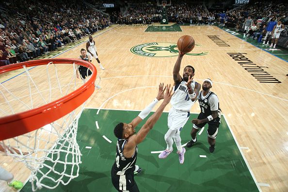 MILWAUKEE, WI - NOVEMBER 18: Kyrie Irving #11 of the Dallas Mavericks drives to the basket during the game against the Milwaukee Bucks on November 18, 2023 at the Fiserv Forum Center in Milwaukee, Wisconsin. NOTE TO USER: User expressly acknowledges and agrees that, by downloading and or using this Photograph, user is consenting to the terms and conditions of the Getty Images License Agreement. Mandatory Copyright Notice: Copyright 2023 NBAE (Photo by Gary Dineen/NBAE via Getty Images).